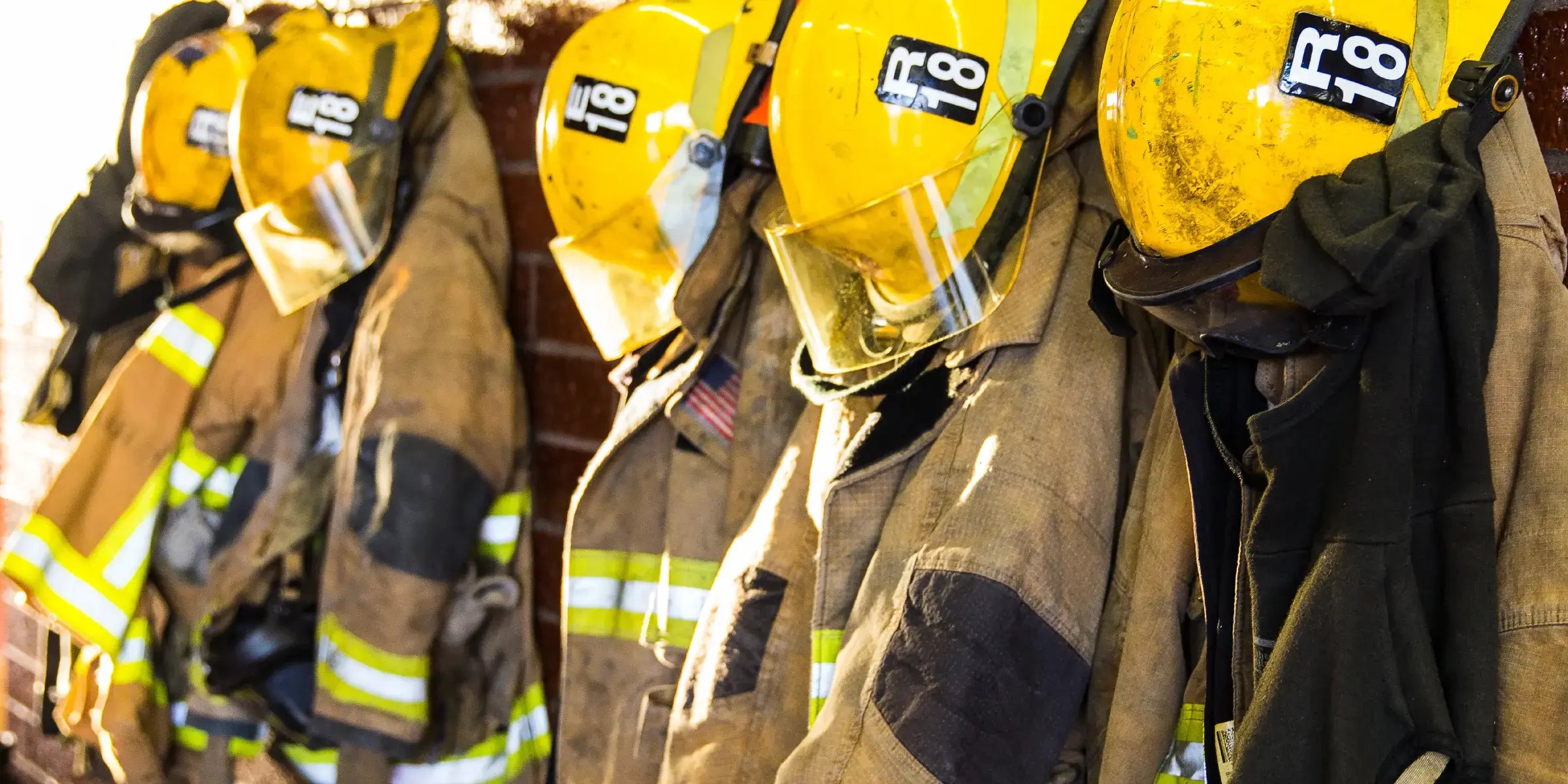 Fire Helmets and Coats Hanging Showing CURVD's Support of First Responders