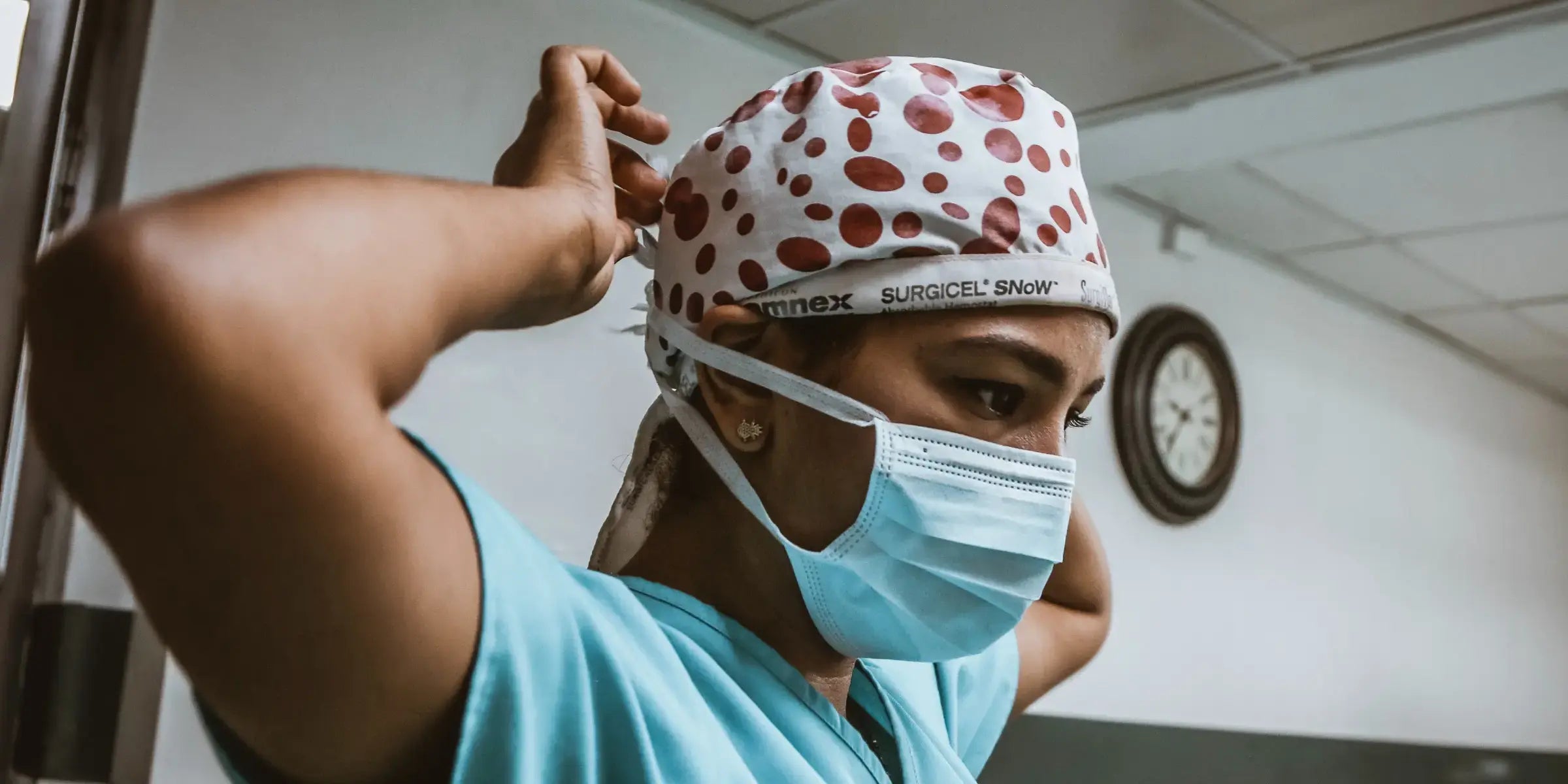 Woman Putting on Medical Mask Showing CURVDs Support for Medical Professionals