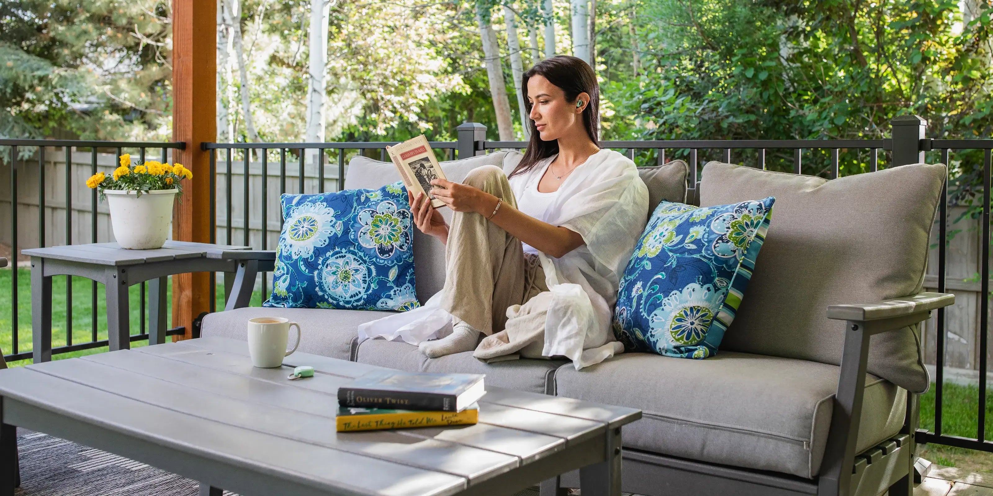 Woman Relaxing Reading Comfortably Outside Wearing CURVD Earplugs