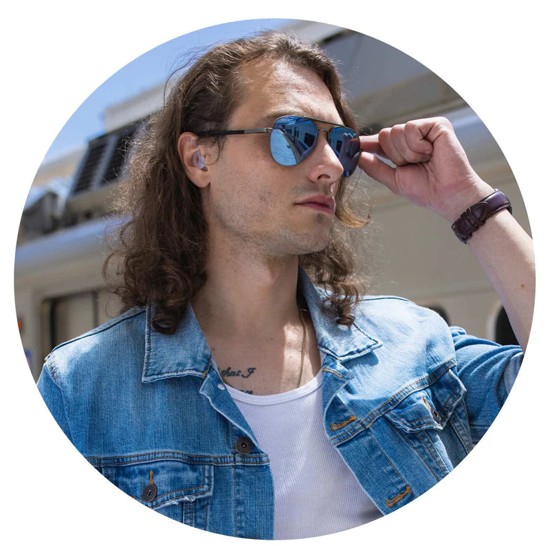 Young Stylish Man Wearing CURVD Earplugs and Sunglasses for Travel, Anxiety, Sound and Noise Sensitivity